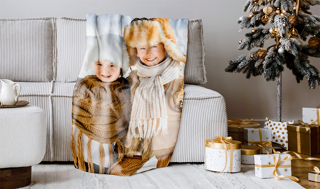 Personalised photo blanket: Mum and baby snuggle on a brown sofa. A unique, cherished keepsake.