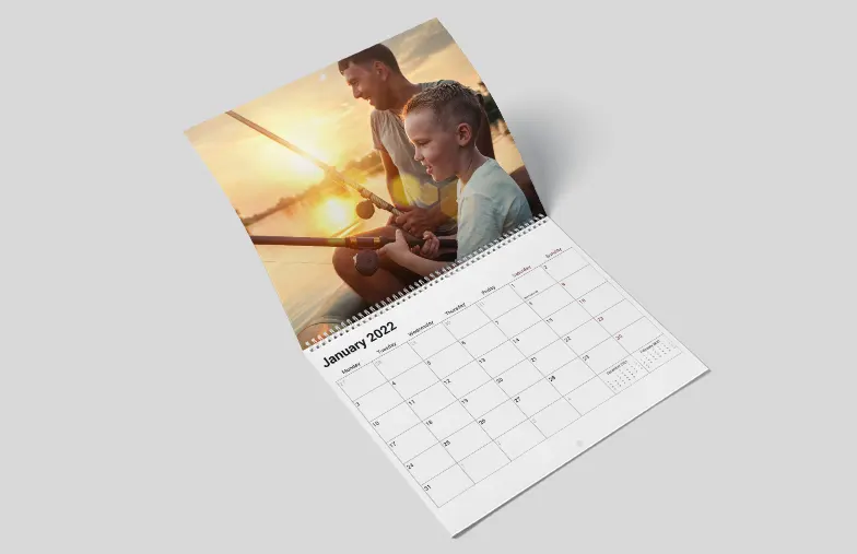 Woman writing on A4 customised wall calendar by printerpix with christmas theme photo
