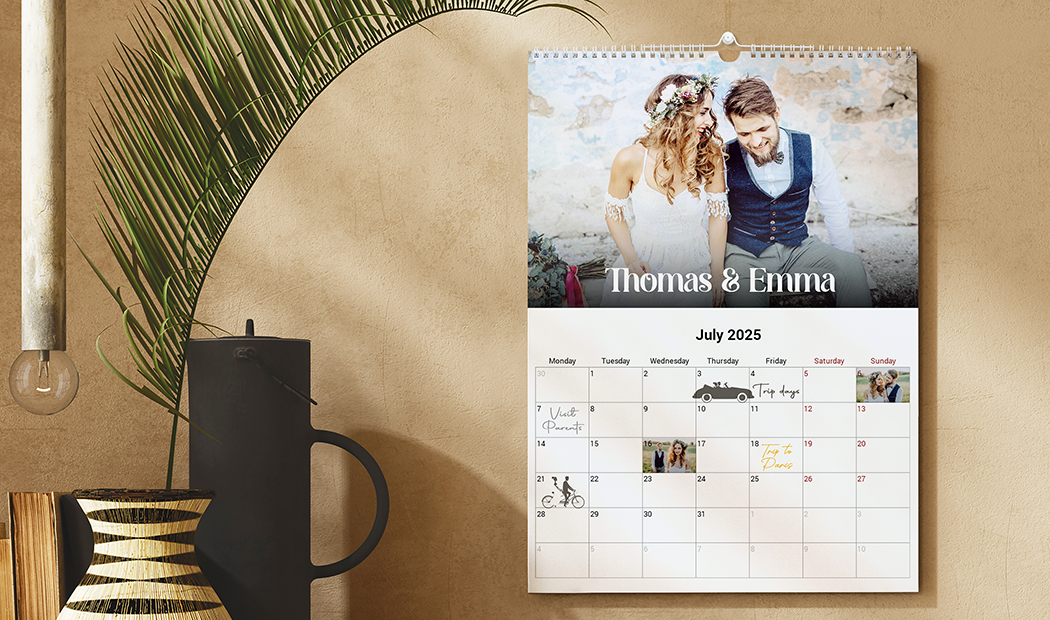 Personalised wall calendar featuring a couple's photo, July 2025 dates, & space for personal photos. Create your bespoke memory keeper!