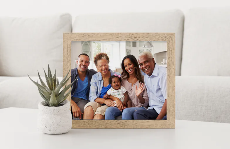 Personalised family photo: three generations smiling together in a light, airy home. Cherish your memories!