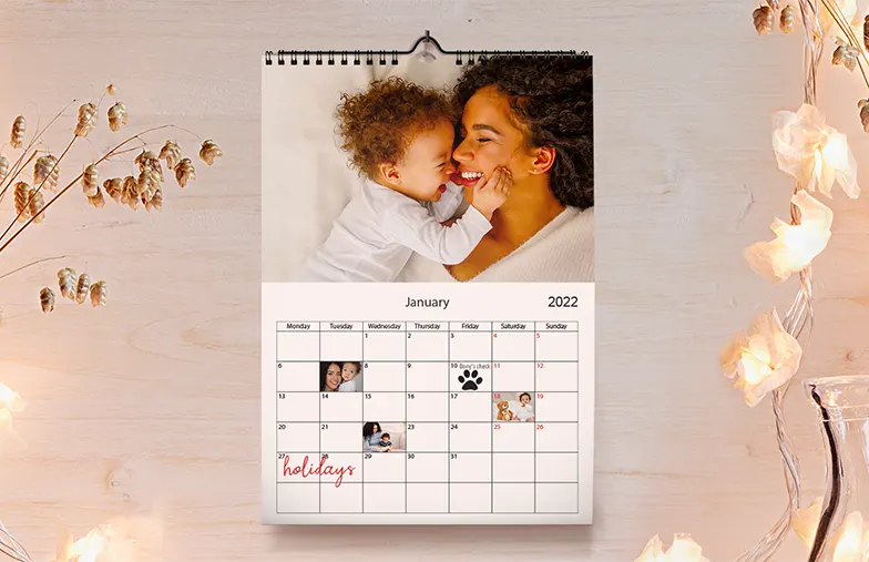 Dog photos on custom design photo calendar hung up on wall